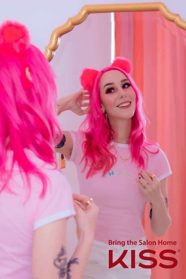 Influencer Megan plays looks at herself in the mirror