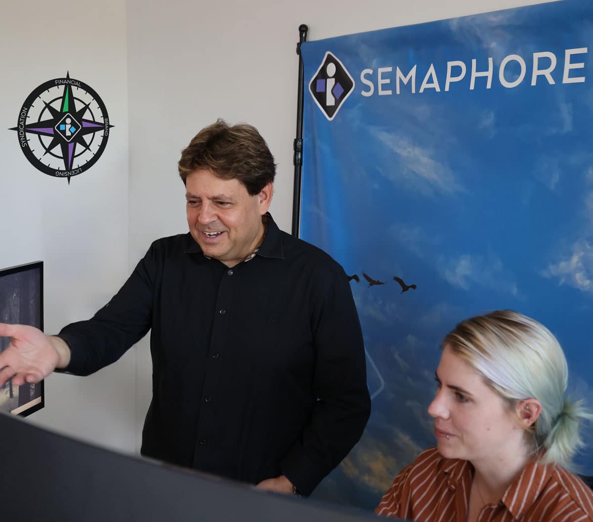 mike bienstock and employee discuss brand solutions at semaphore headquarters
